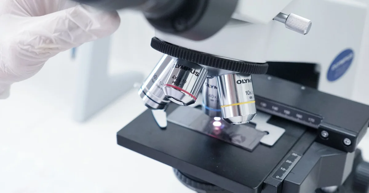 Detailed view of a microscope in a laboratory used in scientific research.