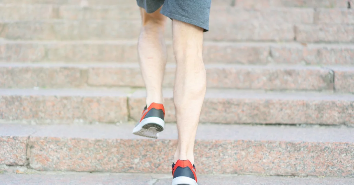 A person in athletic shoes climbing stone steps, showcasing determination and fitness.